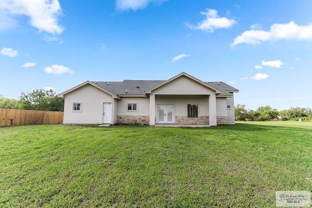 rear view of house with a lawn