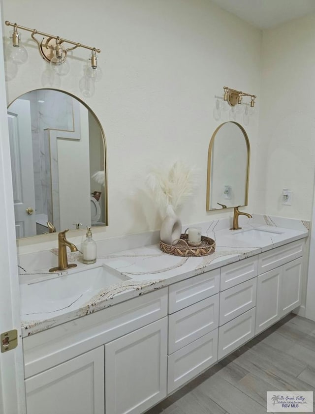 bathroom with vanity and wood-type flooring