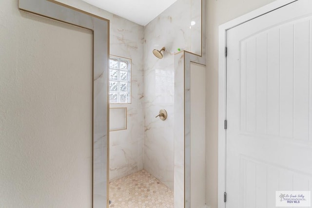 bathroom with tiled shower