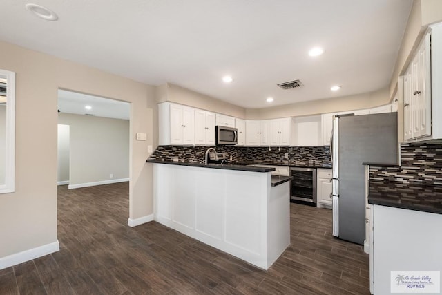 716 E Palm Valley Dr, Harlingen, TX 78550 - kitchen with stainless steel appliances, dark countertops, decorative backsplash, and recessed lighting