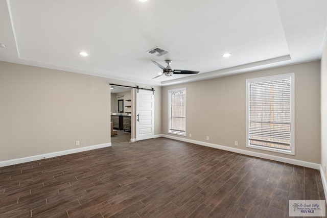 716 E Palm Valley Dr, Harlingen, TX 78550 - unfurnished room with a barn door, plenty of natural light, dark wood-style flooring, a ceiling fan, and recessed lighting