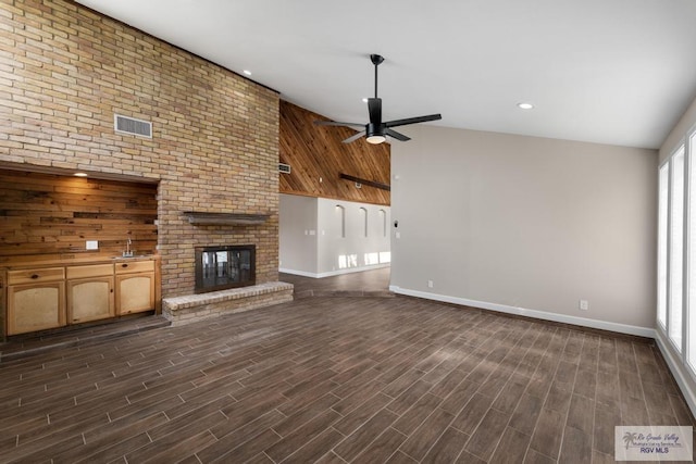 716 E Palm Valley Dr, Harlingen, TX 78550 - unfurnished living room with a ceiling fan, a fireplace, dark wood finished floors, and recessed lighting