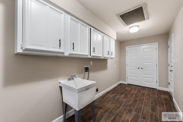 716 E Palm Valley Dr, Harlingen, TX 78550 - laundry room featuring cabinet space, hookup for a washing machine, and dark wood-type flooring