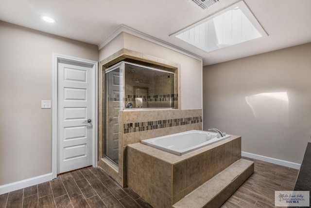 716 E Palm Valley Dr, Harlingen, TX 78550 - bathroom featuring a bath, a stall shower, wood finish floors, and recessed lighting