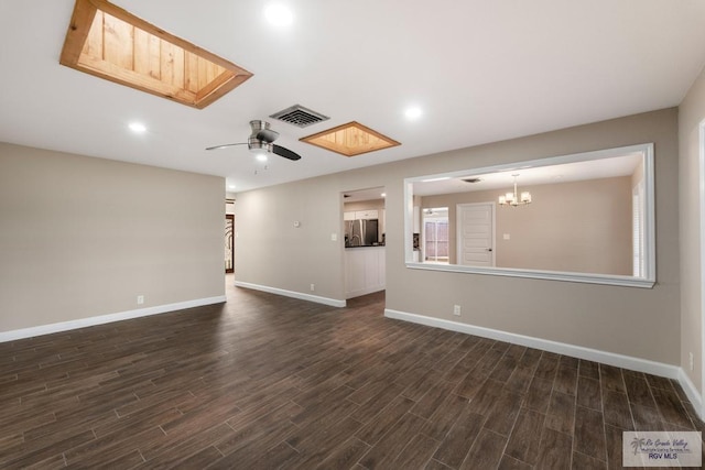 716 E Palm Valley Dr, Harlingen, TX 78550 - unfurnished living room featuring dark wood-style flooring, a skylight, ceiling fan, a chandelier, and recessed lighting