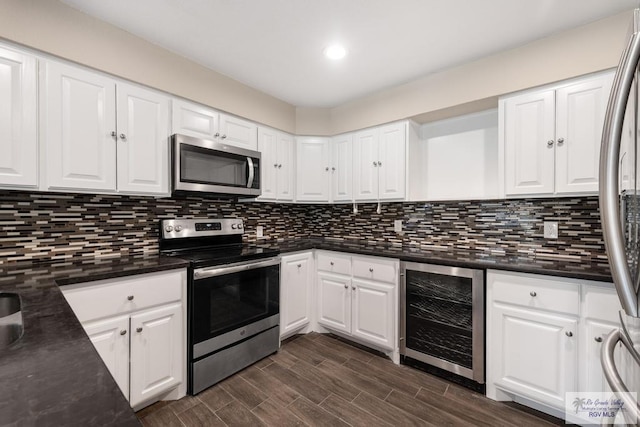 716 E Palm Valley Dr, Harlingen, TX 78550 - kitchen with wine cooler, stainless steel appliances, white cabinetry, and recessed lighting