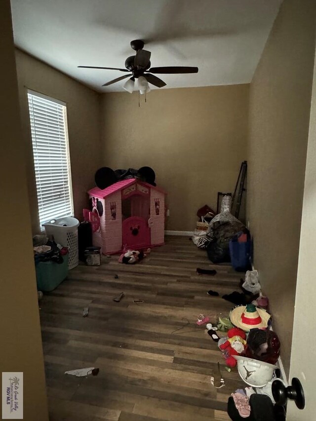 interior space with ceiling fan and dark wood-type flooring