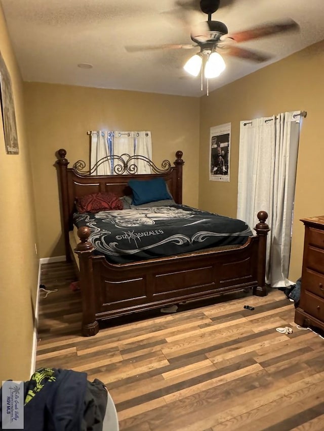 bedroom featuring ceiling fan and light hardwood / wood-style flooring