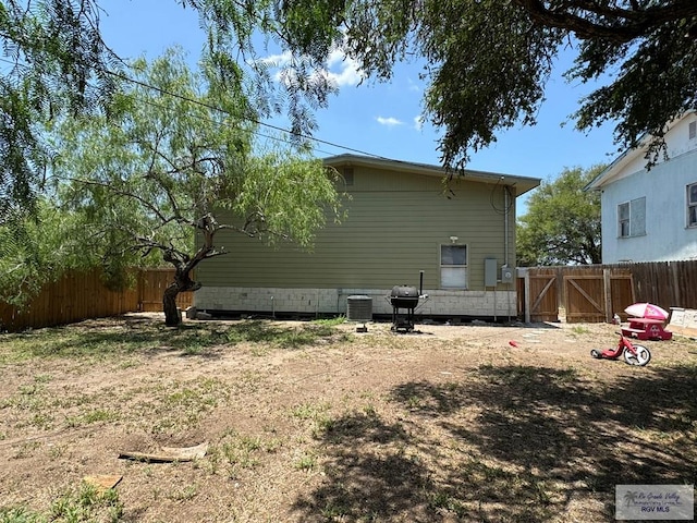 rear view of property featuring cooling unit