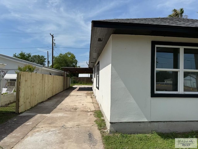 130 W Magnolia Ave, La Feria, TX 78559 - view of property exterior featuring stucco siding and a shingled roof