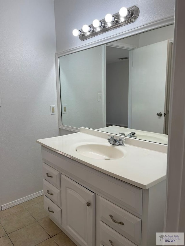 bathroom with tile patterned floors and vanity