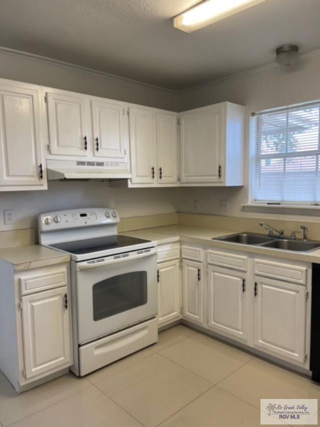 kitchen with white cabinets, electric range, and sink