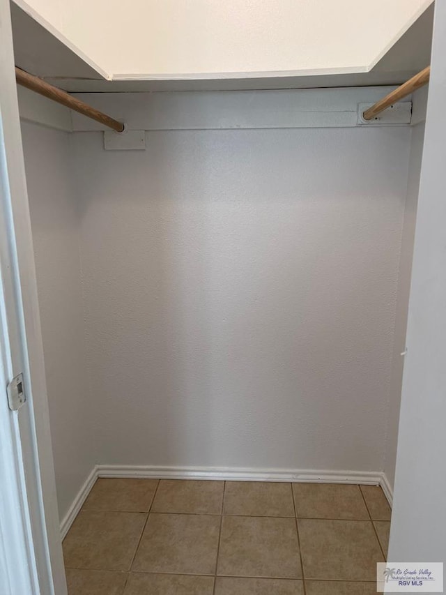 spacious closet with tile patterned floors