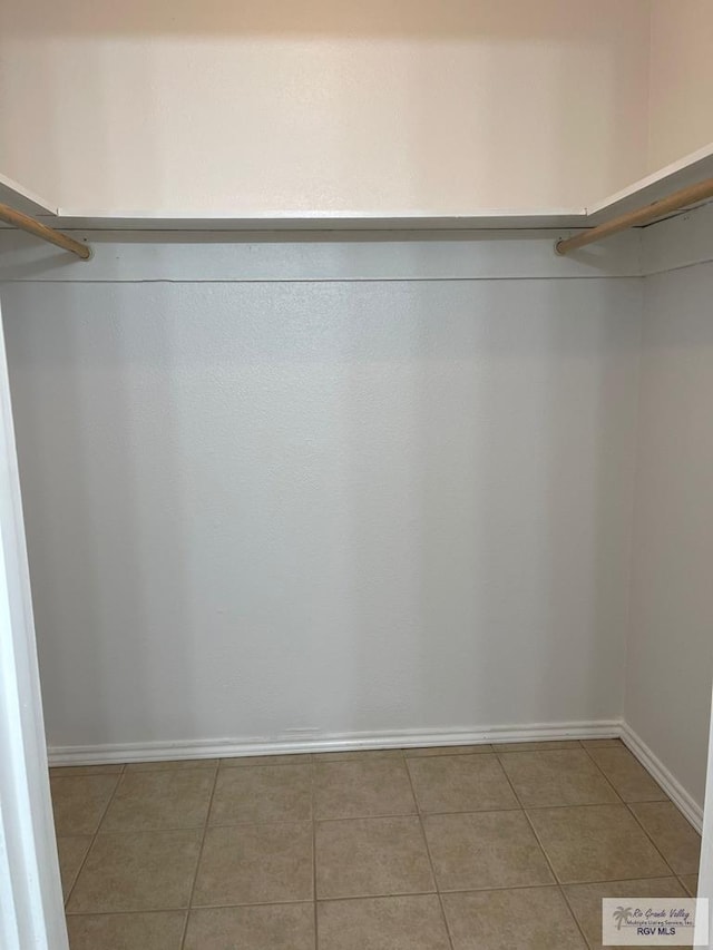 walk in closet featuring tile patterned flooring