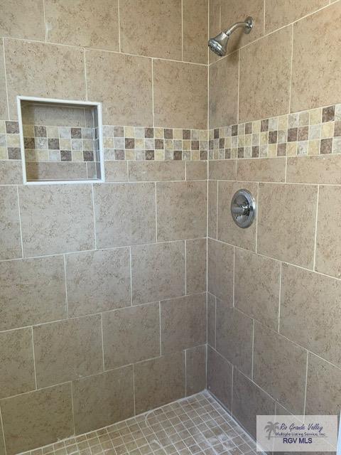 bathroom with a tile shower