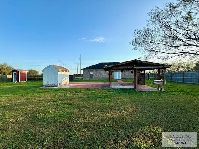 view of yard featuring a gazebo, a patio, and a storage unit