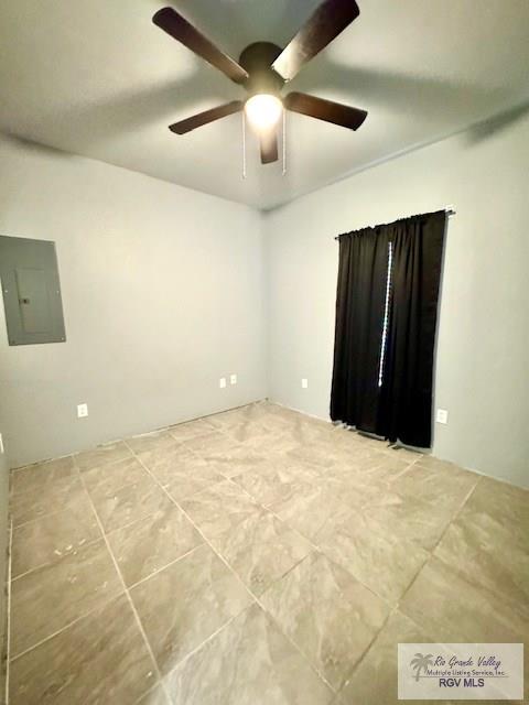 unfurnished room featuring electric panel and ceiling fan