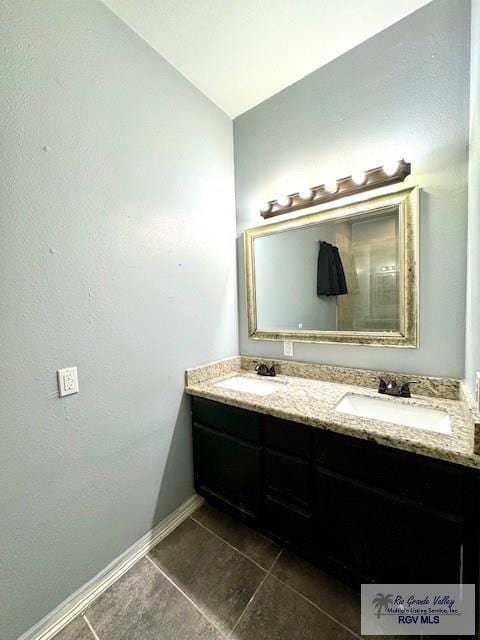 bathroom with tile patterned floors and vanity