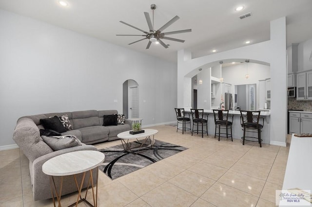 tiled living room featuring ceiling fan