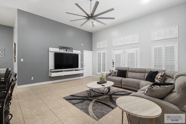 living room with ceiling fan and light tile patterned floors