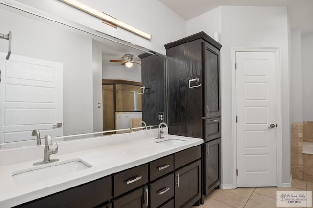 bathroom with ceiling fan, tile patterned flooring, and vanity