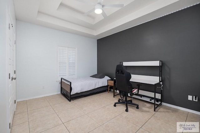 bedroom with light tile patterned flooring, ceiling fan, and a raised ceiling