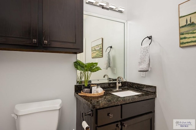 bathroom with toilet and vanity