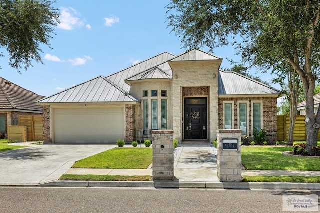 view of front of house featuring a front yard and a garage