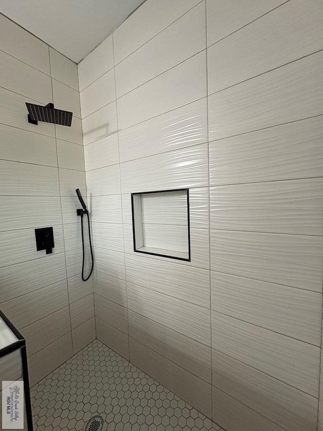 bathroom with tiled shower