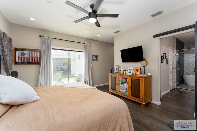 bedroom featuring access to exterior, dark wood-style flooring, visible vents, and a barn door