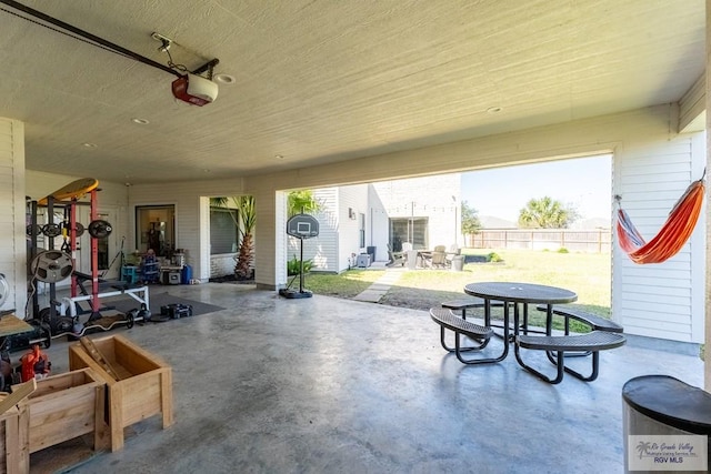 garage with fence and a garage door opener