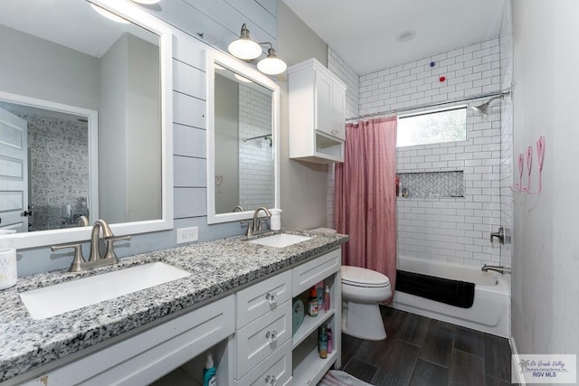 full bath featuring shower / tub combo with curtain, a sink, toilet, and wood tiled floor