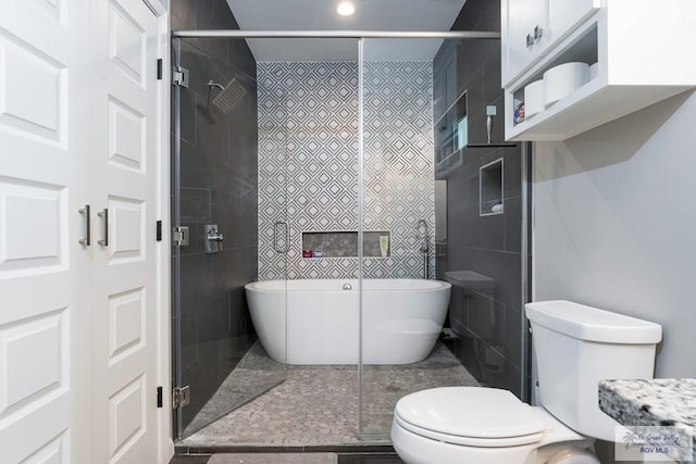 full bath featuring a freestanding bath, a shower stall, and toilet