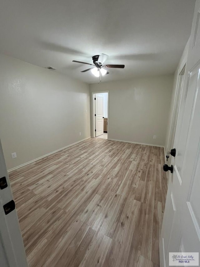 empty room featuring ceiling fan and light hardwood / wood-style floors