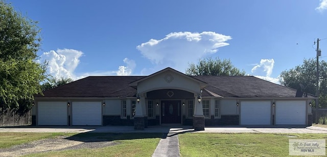 ranch-style home with a front yard and a garage