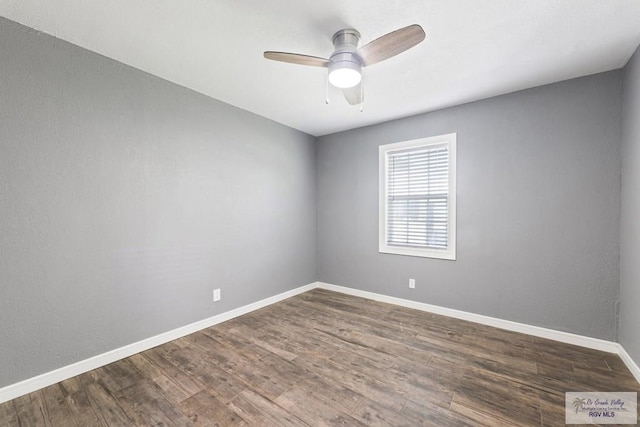 unfurnished room with ceiling fan and dark wood-type flooring