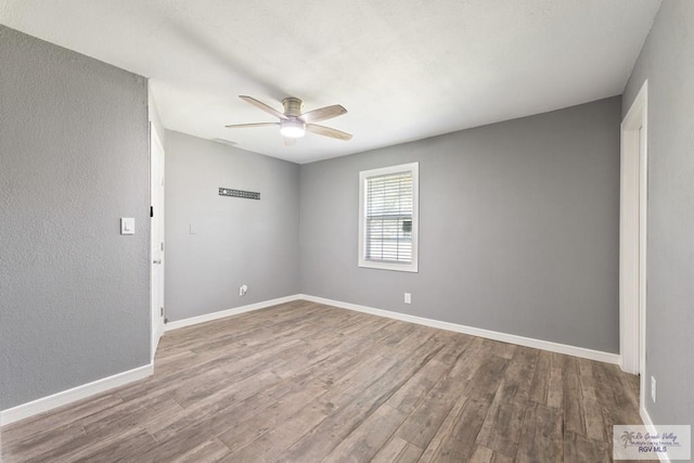 unfurnished room with hardwood / wood-style floors and ceiling fan