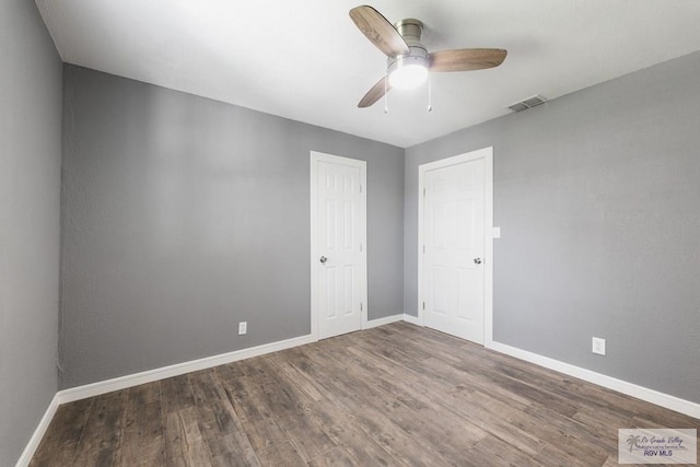 spare room with wood-type flooring and ceiling fan