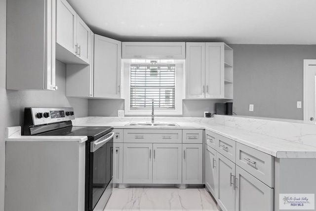 kitchen with stainless steel electric stove, light stone counters, kitchen peninsula, and sink