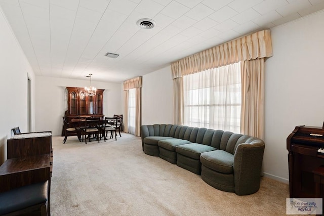 living room with light carpet and a chandelier