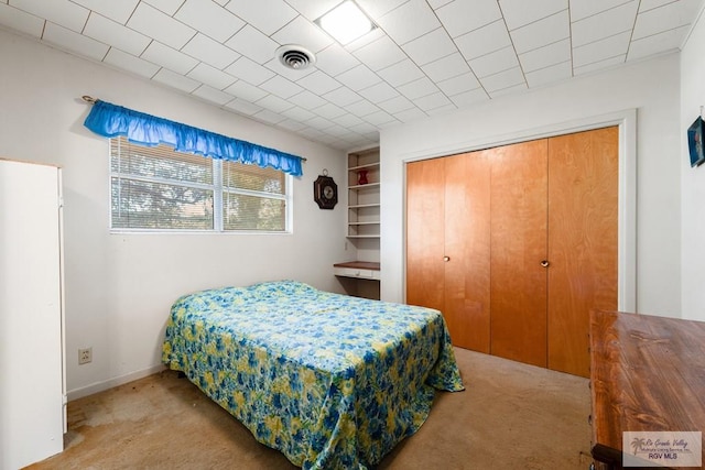 bedroom featuring light colored carpet and a closet