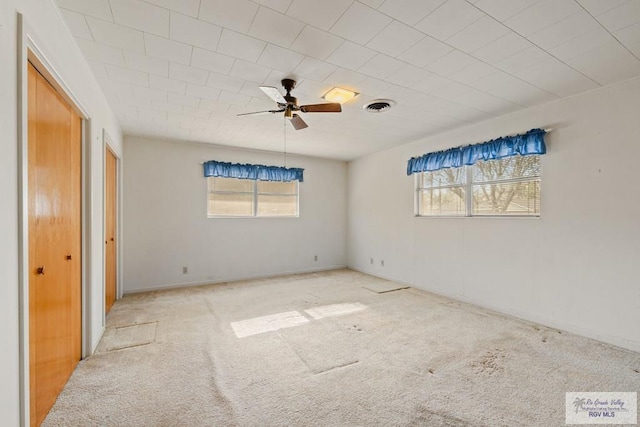 empty room featuring light carpet and ceiling fan