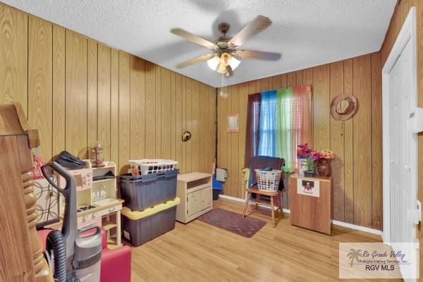 interior space with ceiling fan