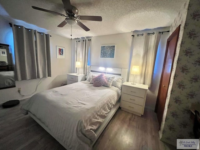 bedroom featuring a textured ceiling, ceiling fan, and wood finished floors