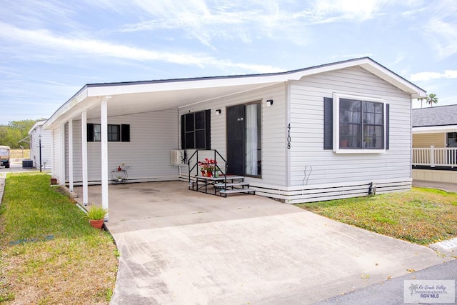 manufactured / mobile home featuring a front lawn and cooling unit