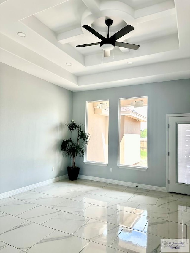 spare room with a tray ceiling, marble finish floor, recessed lighting, ceiling fan, and baseboards