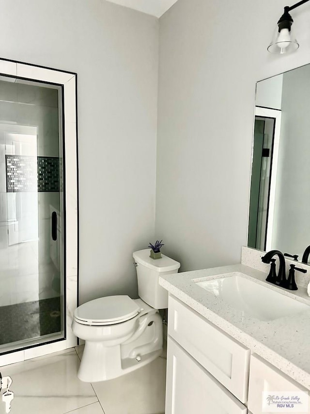 bathroom featuring a shower stall, vanity, and toilet