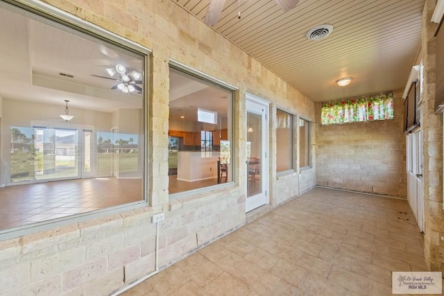 interior space with a ceiling fan and visible vents