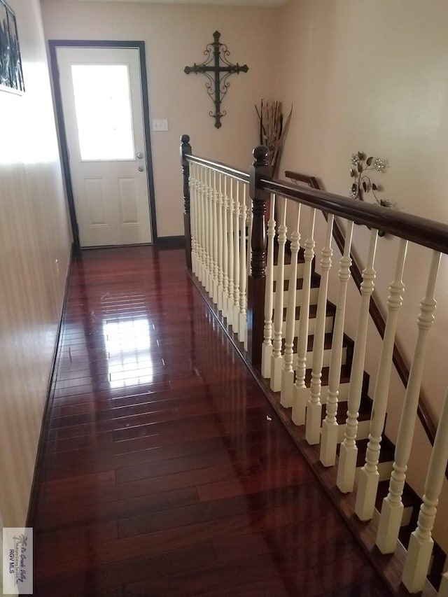 hall featuring hardwood / wood-style flooring, a healthy amount of sunlight, and baseboards