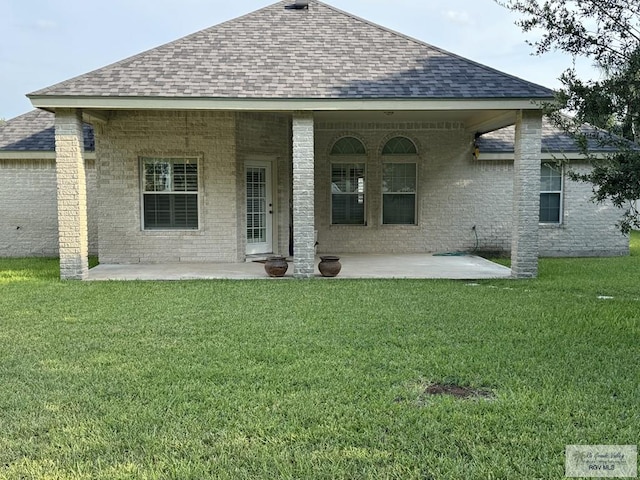 back of house with a yard and a patio area